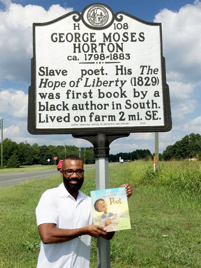 Don posing inder Poet historical marker